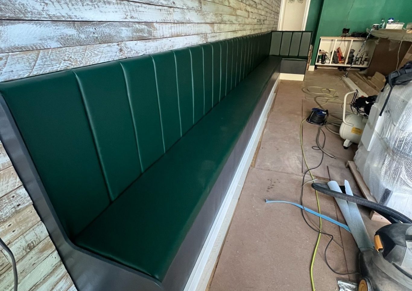Green upholstered commercial bench for Fratteli Italian Restaurant, Hebden Bridge, crafted by Greenwood Upholstery, Calder Valley.

