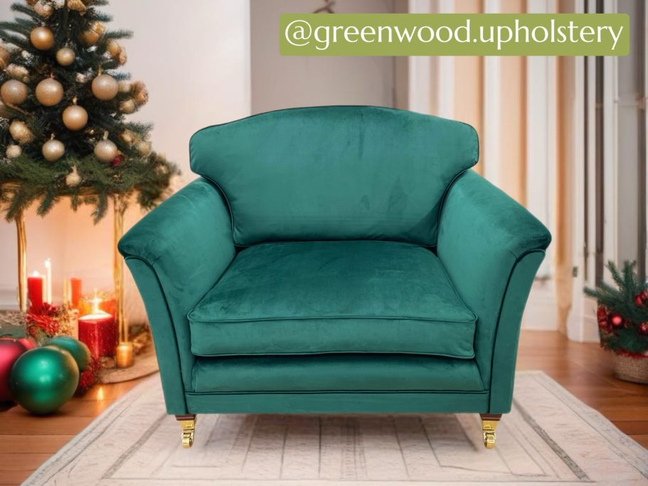 Teal upholstered armchair on a light rug, festive decorations in the background.